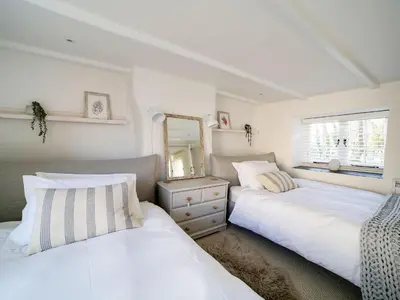 two beds sitting next to each other in a bedroom at Bell Cottage in Saint Teath