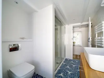 a bathroom with a toilet and a sink at Bell Cottage in Saint Teath