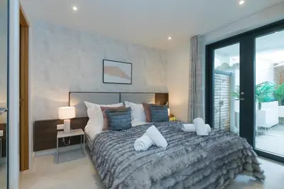 a bedroom with a large bed with two white pillows at Monowai Heights in St Ives