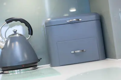 a tea kettle on a counter next to a toaster at Monowai Heights in St Ives