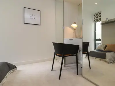 a living room with a chair and a couch at Monowai Heights in St Ives