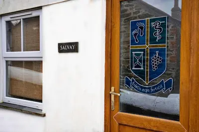 a door with a sign on it next to a window at Finest Retreats - Salvay in Porthleven