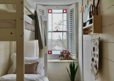 a bedroom with a bunk bed and a window at Wheelwright House in Bodmin