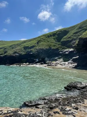 a view of a beach with rocks and the ocean at Wheelwright House in Bodmin