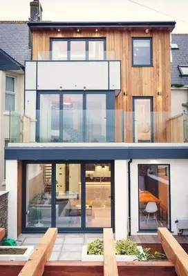 a house with large glass windows and a patio at George24 - spectacular, 5 minutes to the beach in Newquay
