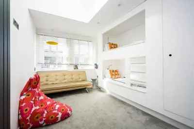 a living room with a couch and a window at George24 - spectacular, 5 minutes to the beach in Newquay