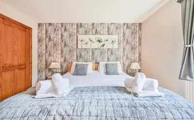 a bedroom with a large bed with white sheets and pillows at 3 bed Lodge with EV point in Truro