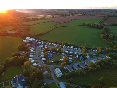 an aerial view of a parking lot with tents at Polladras Holiday Park in Helston