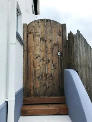 a wooden door on the side of a building at White Eden - explore Cornwall from a comfy central appartment in St Austell