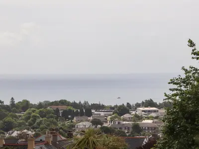a city with houses and the ocean in the background at Sea View in St Austell