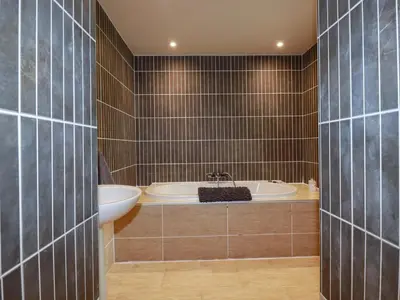a bathroom with a tub and a sink at Sea View in St Austell