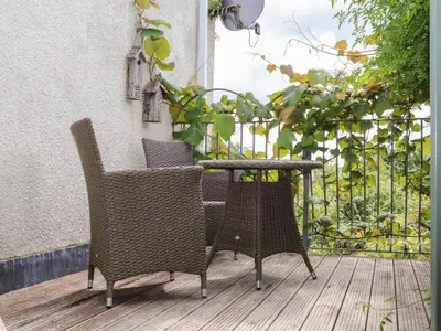an outdoor table and chairs on a patio at Sea View in St Austell