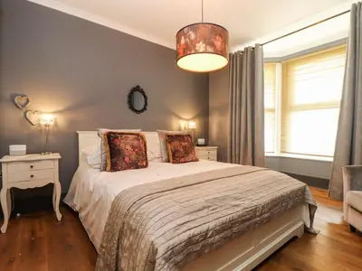 a bedroom with a bed and a window at Hillcroft in St Austell