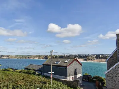 a building on the side of a body of water at Apartment 15 Harvest Moon in Newquay