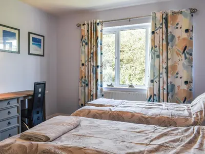 a bedroom with two beds and a window at Apartment 15 Harvest Moon in Newquay
