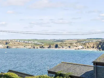 a view of a large body of water with houses at Apartment 15 Harvest Moon in Newquay