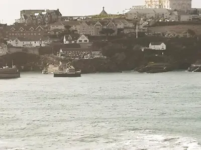 a view of a body of water with buildings and houses at Apartment 15 Harvest Moon in Newquay