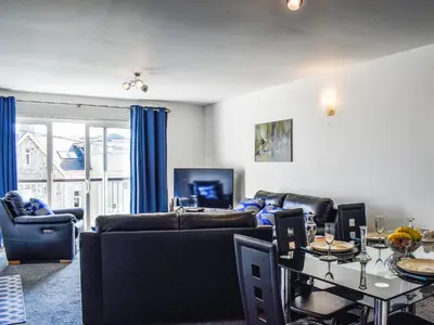 a living room with a couch and a table at Apartment 15 Harvest Moon in Newquay