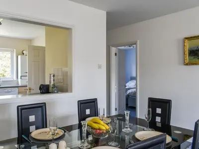 a dining room with a table and a mirror at Apartment 15 Harvest Moon in Newquay