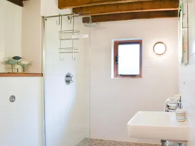 a bathroom with a shower and a sink at Chy An Dour in Davidstow