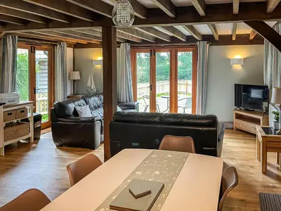 a living room with a table and a couch at Chy An Dour in Davidstow