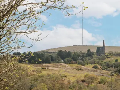a view of a hill with a tower in the distance at Henwood Barn in Liskeard