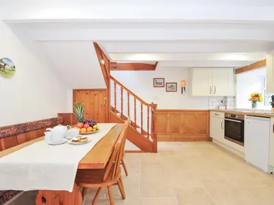 a kitchen with a table with a bowl of fruit on it at Henwood Barn in Liskeard