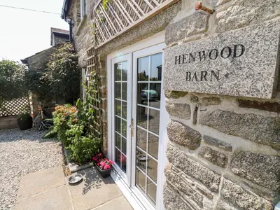 a brick building with a sign that reads herwood barn at Henwood Barn in Liskeard
