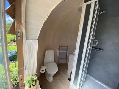 a bathroom with a toilet inside of a house at Prosecco - Lydcott Glamping Cornwall, sea views in East Looe