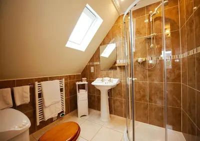 a bathroom with a sink and a shower at Orchard House Wadebridge Self Catering in Wadebridge