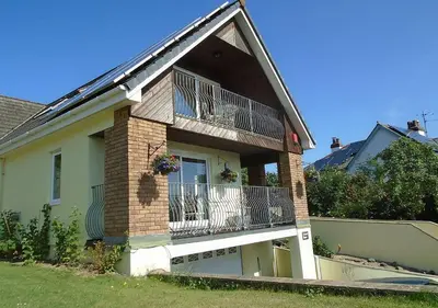 a house with a balcony on the side of it at Orchard House Wadebridge Self Catering in Wadebridge