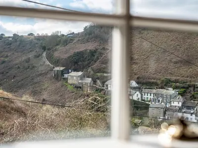 a view from a window of a town on a hill at Mermaid Cottage in Port Isaac