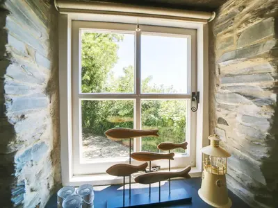 a window in a room with three chairs in front of it at Stone Barn in Camelford