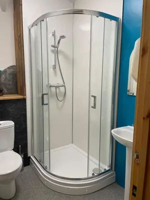 a shower stall in a bathroom with a toilet at Rosehip Barn in Launceston