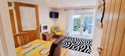 a dining room with a table and a window at Looe Holiday Home Cornwall Sleeps 2 Self Catering No Pets in Looe
