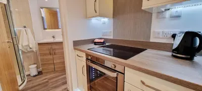 a kitchen with a stove and a counter top at Looe Holiday Home Cornwall Sleeps 2 Self Catering No Pets in Looe