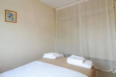 a bedroom with a bed with two towels on it at Sunny Corner Cottage in Hayle
