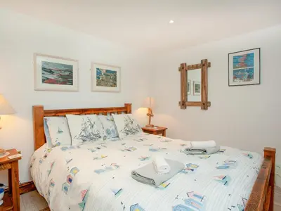 a bedroom with a bed with towels on it at Wheal Trenwith Cottage in St Ives
