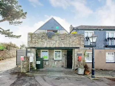 an old stone building with a large doorway at Wheal Trenwith Cottage in St Ives