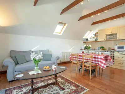 a living room with a couch and a table at Wheal Trenwith Cottage in St Ives