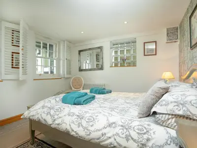 a bedroom with a bed with two pillows on it at Wheal Trenwith Cottage in St Ives