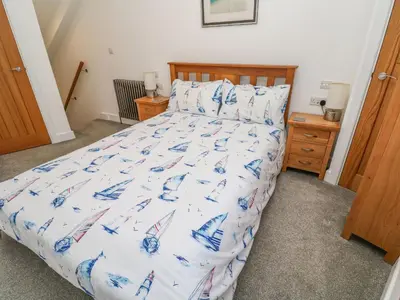 a bedroom with a bed with an american flag bedspread at Blue Skies in Hayle