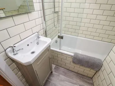 a bathroom with a sink and a shower and a tub at Blue Skies in Hayle