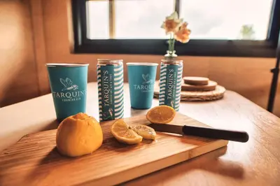 a cutting board with oranges and cups on a table at Luxury Glamping Cabin with Outdoor Bath on Cornish Meadow in Truro