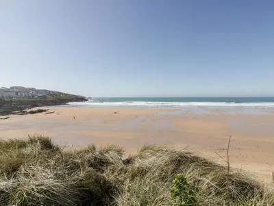 a sandy beach with the ocean in the background at Fistral Pearl in Newquay