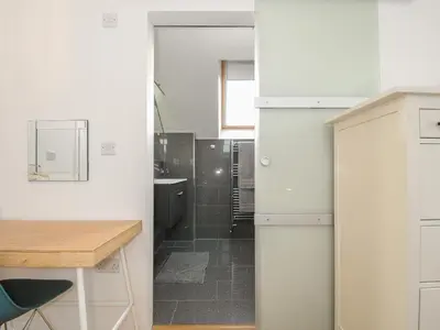 a white bathroom with a sink and a shower at Spires in Truro