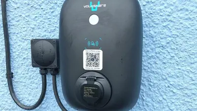 a cell phone is hooked up to a charger at F13 Trefusis, Riviere Towans in Hayle