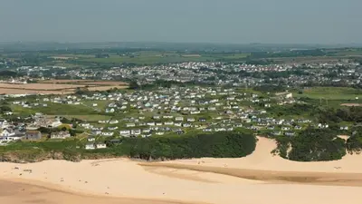 an aerial view of a town on the beach at F24 Glenara, Riviere Towans in Hayle