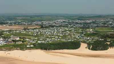 an aerial view of a town on a sandy beach at F30 Fernside, Riviere Towans in Hayle
