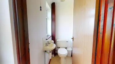 a small bathroom with a toilet and a sink at F30 Fernside, Riviere Towans in Hayle